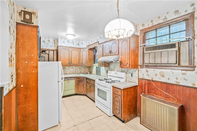 1484 E 16th St, Brooklyn, NY 11230 - kitchen featuring white appliances, wallpapered walls, a chandelier, brown cabinets, and light countertops