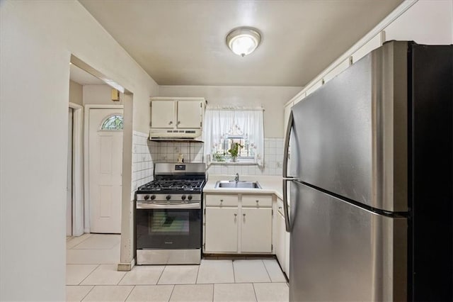 628 Thomas S Boyland St, Brooklyn, NY 11212 - kitchen featuring stainless steel appliances, under cabinet range hood, backsplash, a sink, and light tile patterned floors