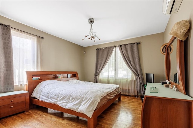 2077 E 22nd St, Brooklyn, NY 11229 - bedroom with a wall mounted AC, multiple windows, and light wood finished floors