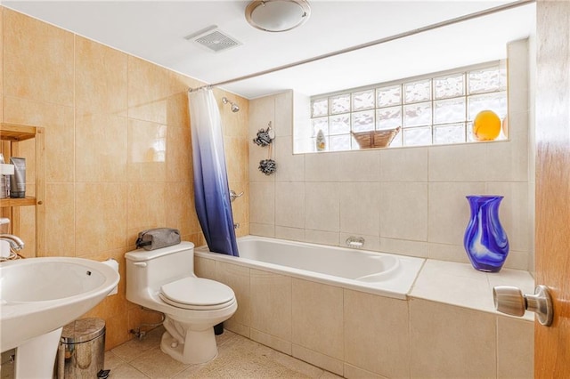 2077 E 22nd St, Brooklyn, NY 11229 - full bath with tile walls, tiled shower / bath, toilet, a sink, and tile patterned flooring