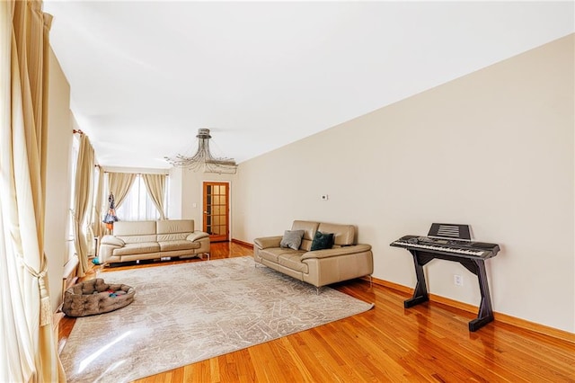 2077 E 22nd St, Brooklyn, NY 11229 - living area featuring a chandelier, wood finished floors, and baseboards