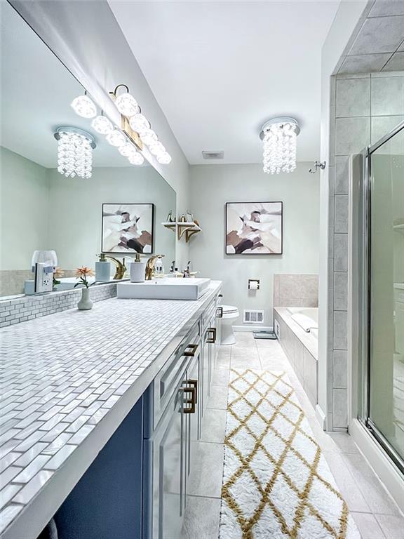139 Tennyson Dr, Staten Island, NY 10308 - bathroom with a chandelier, vanity, a bath, and a stall shower