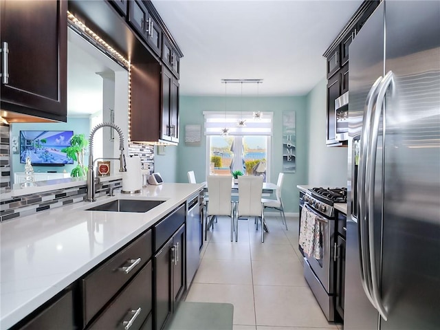 139 Tennyson Dr, Staten Island, NY 10308 - kitchen with stainless steel appliances, a sink, light countertops, and decorative light fixtures