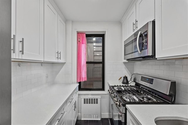 9040 Fort Hamilton Pkwy Unit 2I, Brooklyn, NY 11209 - kitchen featuring appliances with stainless steel finishes, radiator heating unit, and white cabinetry