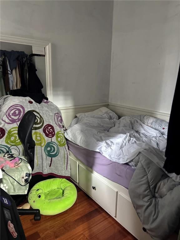 537 56th St, Brooklyn, NY 11220 - bedroom with wood finished floors and a wainscoted wall