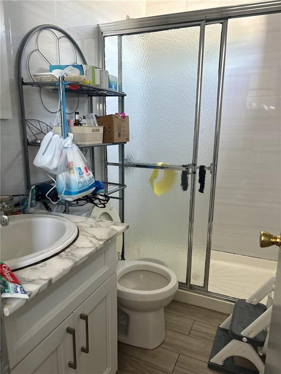 537 56th St, Brooklyn, NY 11220 - bathroom with a stall shower, vanity, and toilet