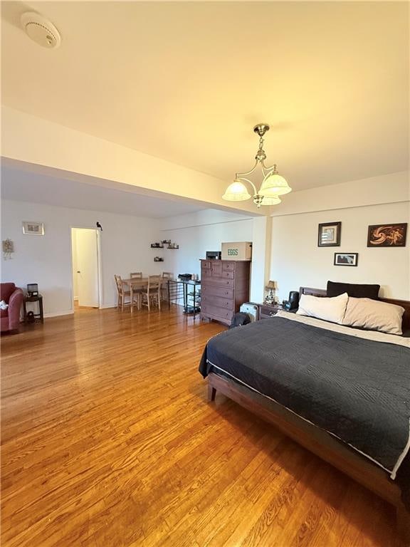 9511 Shore Rd Unit 617, Brooklyn, NY 11209 - bedroom with a chandelier and light wood-style floors