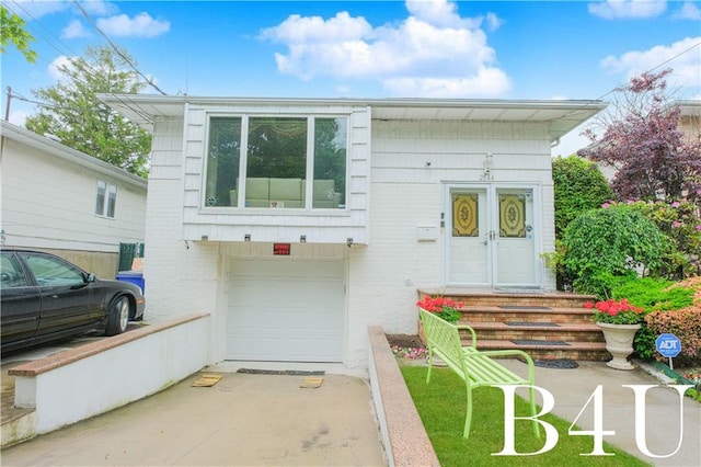 2544 E 64th St, Brooklyn, NY 11234 - view of front facade featuring an attached garage and brick siding