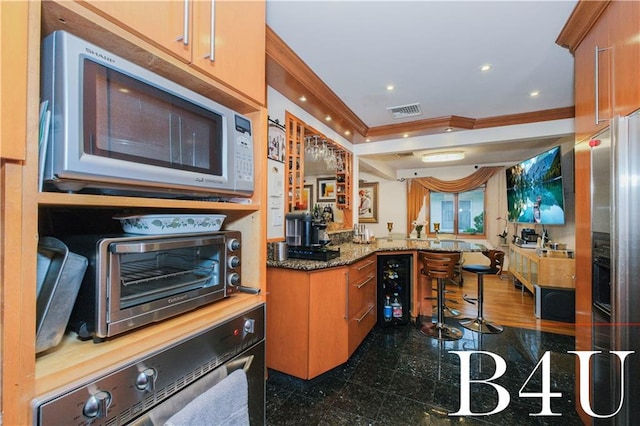 2544 E 64th St, Brooklyn, NY 11234 - kitchen featuring white microwave, ornamental molding, oven, granite tiled floors, and stone countertops