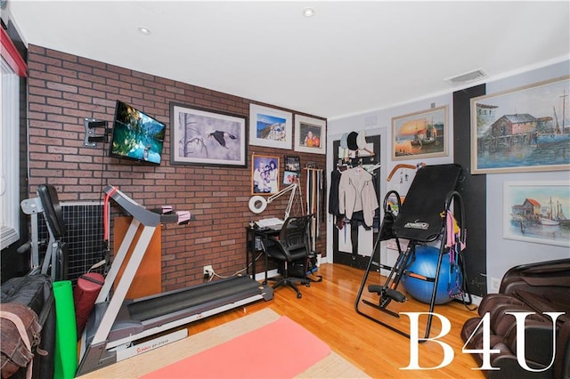 2544 E 64th St, Brooklyn, NY 11234 - exercise room featuring wood finished floors and brick wall