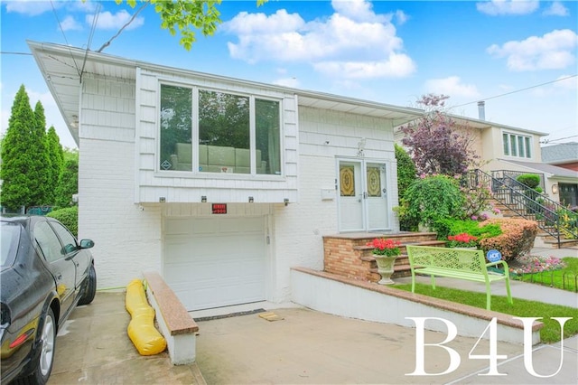 2544 E 64th St, Brooklyn, NY 11234 - view of front of property with brick siding, a garage, and driveway