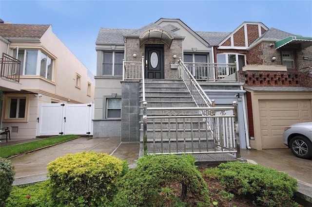119 Langham St, Brooklyn, NY 11235 - view of front of property featuring a gate, a garage, stairway, stucco siding, and concrete driveway
