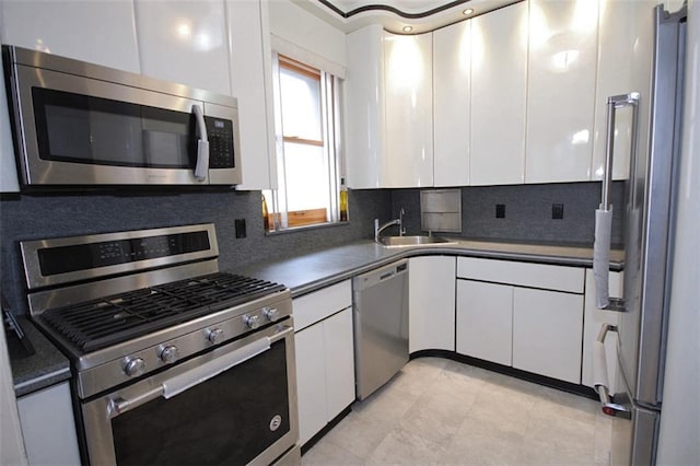 119 Langham St, Brooklyn, NY 11235 - kitchen featuring appliances with stainless steel finishes, white cabinets, tasteful backsplash, and light tile patterned floors