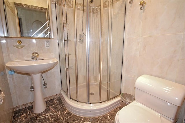 119 Langham St, Brooklyn, NY 11235 - full bath featuring tile walls, a shower stall, and marble tiled floors