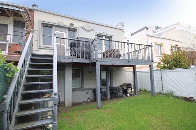 119 Langham St, Brooklyn, NY 11235 - back of house with stucco siding, stairs, and a deck