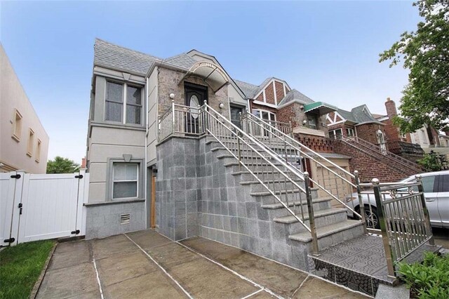 119 Langham St, Brooklyn, NY 11235 - view of front of home featuring a gate and a shingled roof