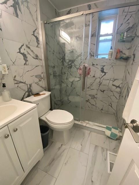 119 Langham St, Brooklyn, NY 11235 - full bathroom with a marble finish shower, vanity, and marble finish floors
