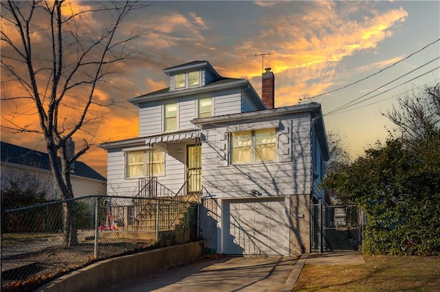 432 Neckar Ave, Staten Island, NY 10304 - rear view of house with a chimney, an attached garage, concrete driveway, and a gate