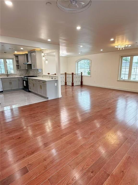 30 Church Ave, Staten Island, NY 10314 - unfurnished living room featuring healthy amount of natural light, light wood-style flooring, recessed lighting, and baseboards