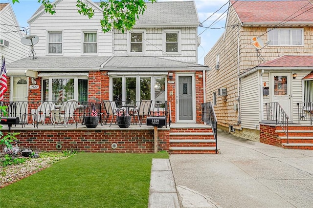 1929 E 36th St, Brooklyn, NY 11234 - view of front of home with roof with shingles, a front yard, and brick siding