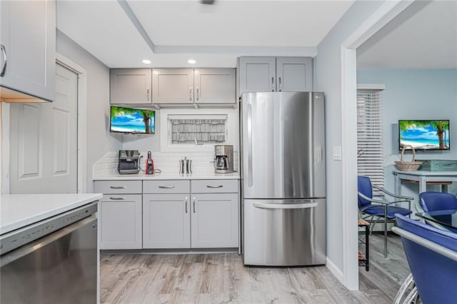 1929 E 36th St, Brooklyn, NY 11234 - kitchen featuring stainless steel appliances, gray cabinets, light countertops, light wood finished floors, and recessed lighting