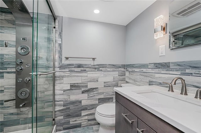 1929 E 36th St, Brooklyn, NY 11234 - full bath featuring tile walls, toilet, a stall shower, vanity, and wainscoting