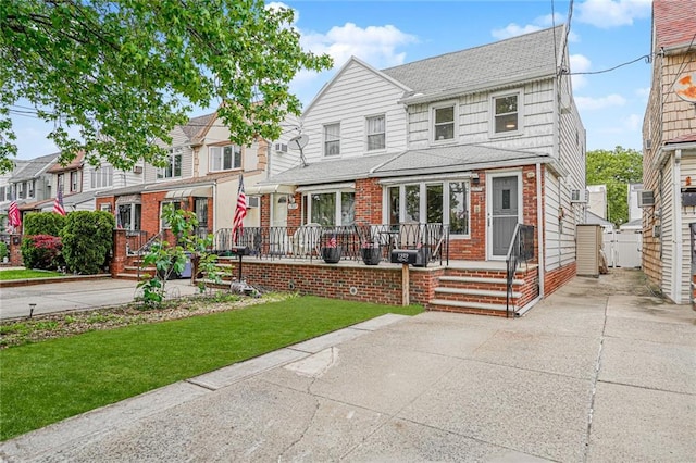 1929 E 36th St, Brooklyn, NY 11234 - view of front of property with brick siding, a front yard, roof with shingles, and a porch