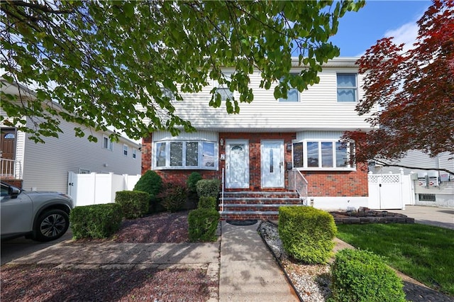 223 Abingdon Ave, Staten Island, NY 10308 - view of front facade with brick siding, entry steps, and a gate