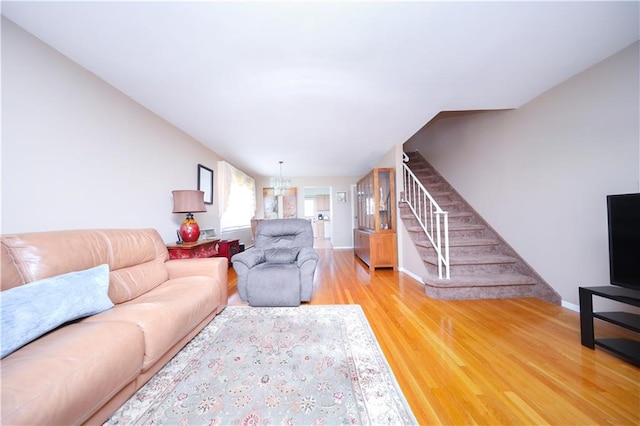 223 Abingdon Ave, Staten Island, NY 10308 - living area featuring stairs, light wood-type flooring, a chandelier, and baseboards