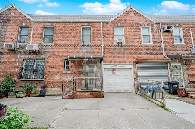 1922 E 16th St, Brooklyn, NY 11229 - view of property with driveway, brick siding, and a garage