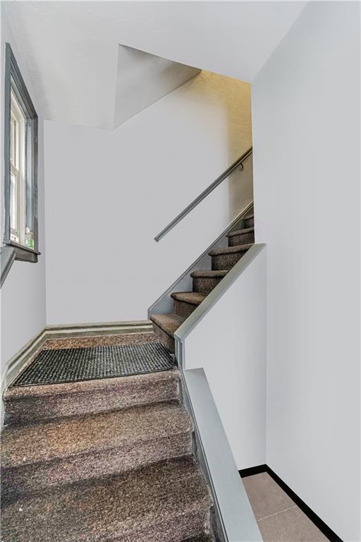 1922 E 16th St, Brooklyn, NY 11229 - stairway with baseboards and tile patterned flooring