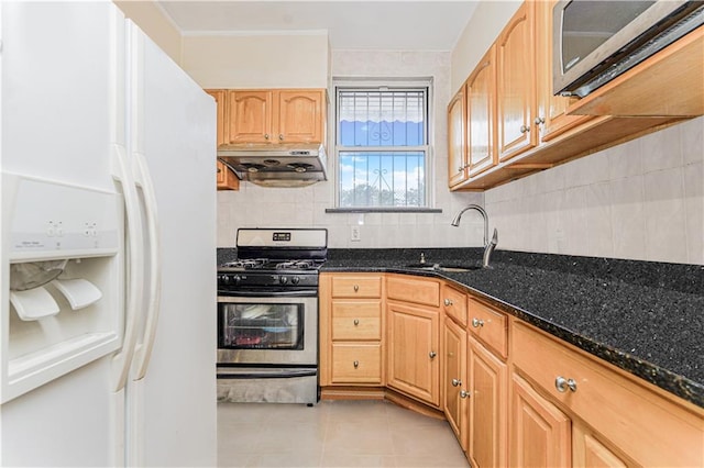 1922 E 16th St, Brooklyn, NY 11229 - kitchen featuring stainless steel appliances, exhaust hood, dark stone counters, backsplash, and light tile patterned flooring