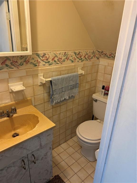 4515 Foster Ave, Brooklyn, NY 11203 - half bathroom with tile walls, vanity, toilet, tile patterned flooring, and wainscoting