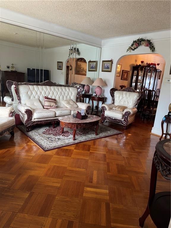 4515 Foster Ave, Brooklyn, NY 11203 - living area featuring arched walkways, a textured ceiling, and ornamental molding