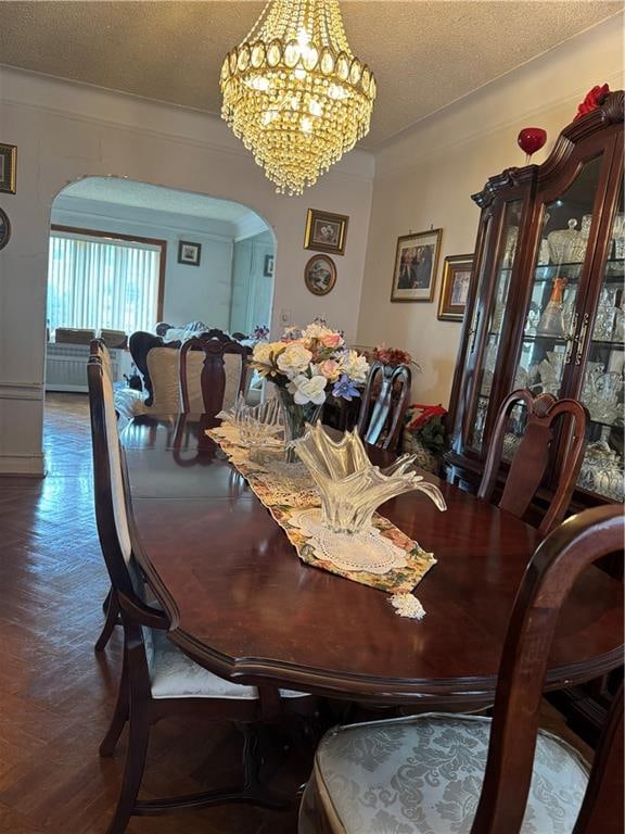 4515 Foster Ave, Brooklyn, NY 11203 - dining area with arched walkways, a chandelier, a textured ceiling, and wood finished floors