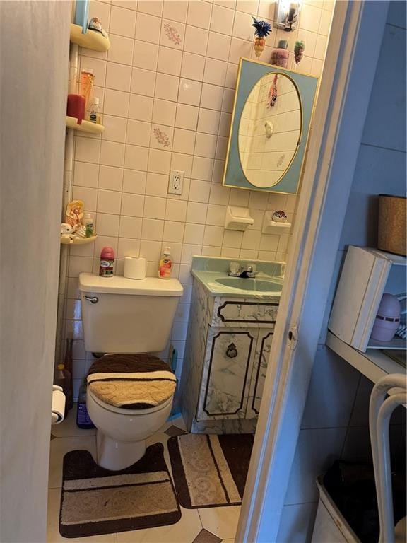 4515 Foster Ave, Brooklyn, NY 11203 - half bathroom with tile walls, toilet, vanity, and tile patterned flooring