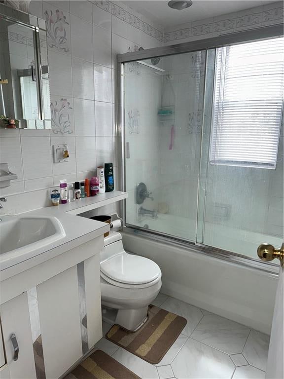 4515 Foster Ave, Brooklyn, NY 11203 - bathroom with combined bath / shower with glass door, vanity, and tile walls