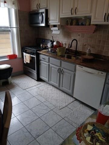 1358 E 35th St, Brooklyn, NY 11210 - kitchen with stainless steel appliances, backsplash, a sink, and dark countertops