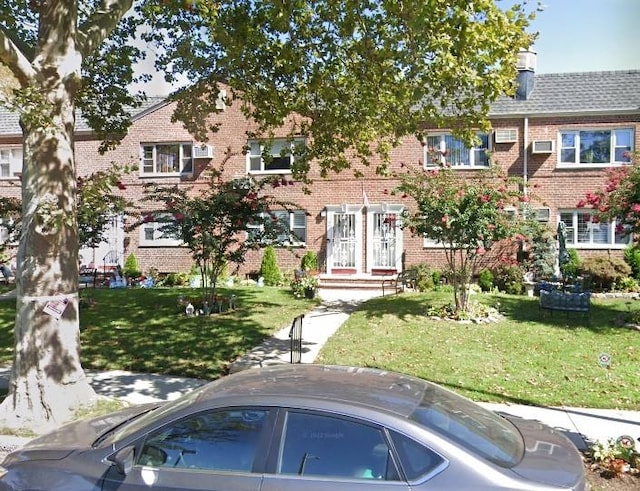 1049 Shore Pkwy Unit 2, Brooklyn, NY 11228 - view of front facade with brick siding and a front yard