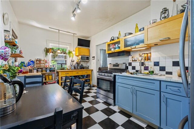 701 127th St, Queens, NY 11356 - kitchen featuring stainless steel appliances, dark floors, backsplash, a sink, and open shelves