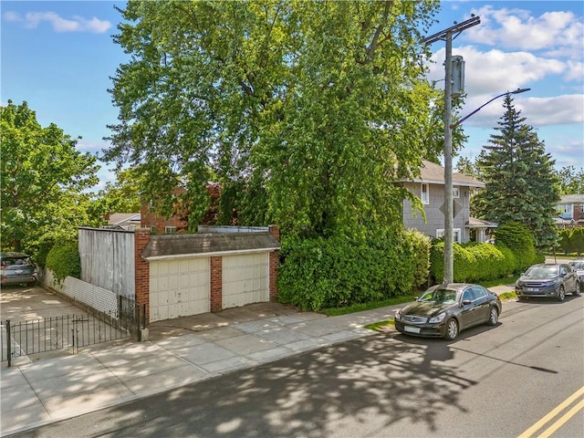 701 127th St, Queens, NY 11356 - view of front of property with a garage, a gate, an outdoor structure, and brick siding