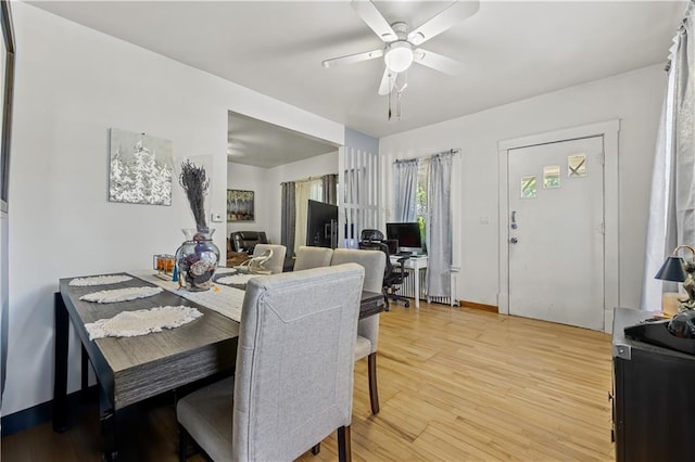 701 127th St, Queens, NY 11356 - dining space featuring a ceiling fan and light wood-style floors