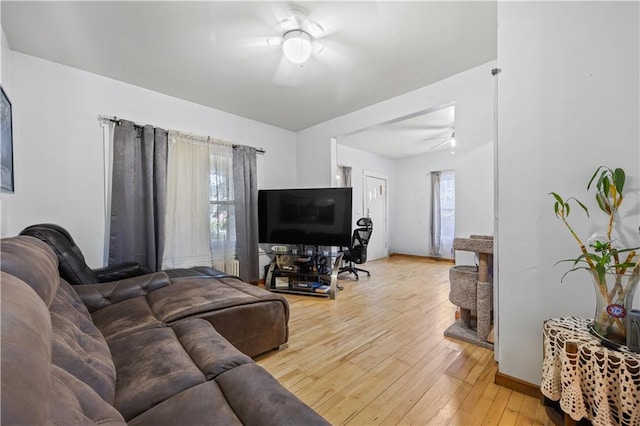 701 127th St, Queens, NY 11356 - living area featuring light wood-style floors, a ceiling fan, and baseboards