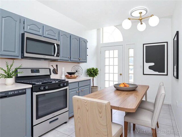 50 Chesebrough St, Staten Island, NY 10312 - kitchen featuring appliances with stainless steel finishes, blue cabinets, light tile patterned floors, and light countertops
