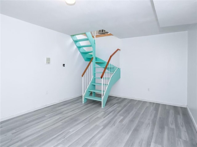50 Chesebrough St, Staten Island, NY 10312 - unfurnished living room featuring wood finished floors, baseboards, and stairway