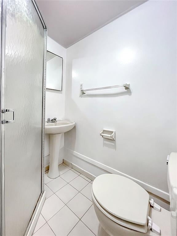 50 Chesebrough St, Staten Island, NY 10312 - bathroom with toilet, a shower stall, tile patterned flooring, baseboards, and a sink