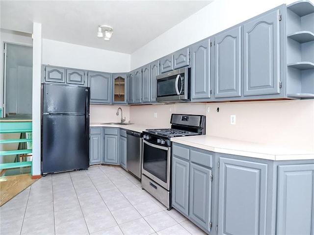 50 Chesebrough St, Staten Island, NY 10312 - kitchen with stainless steel appliances, gray cabinetry, open shelves, and light tile patterned floors