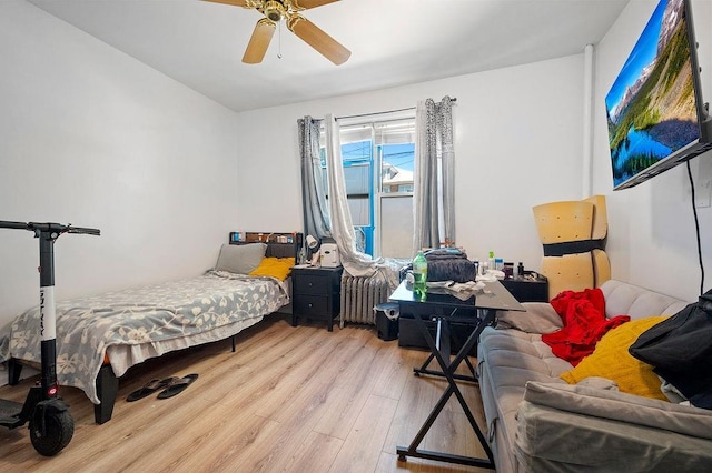 1436 78th St, Brooklyn, NY 11228 - bedroom with radiator, wood finished floors, and a ceiling fan