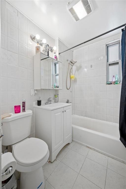 1436 78th St, Brooklyn, NY 11228 - bathroom featuring tile patterned floors, shower / tub combo with curtain, vanity, toilet, and tile walls