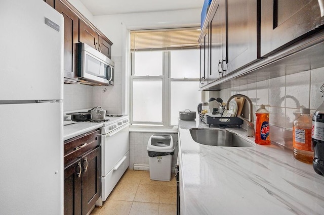 1436 78th St, Brooklyn, NY 11228 - kitchen with white appliances, a sink, plenty of natural light, and light tile patterned floors